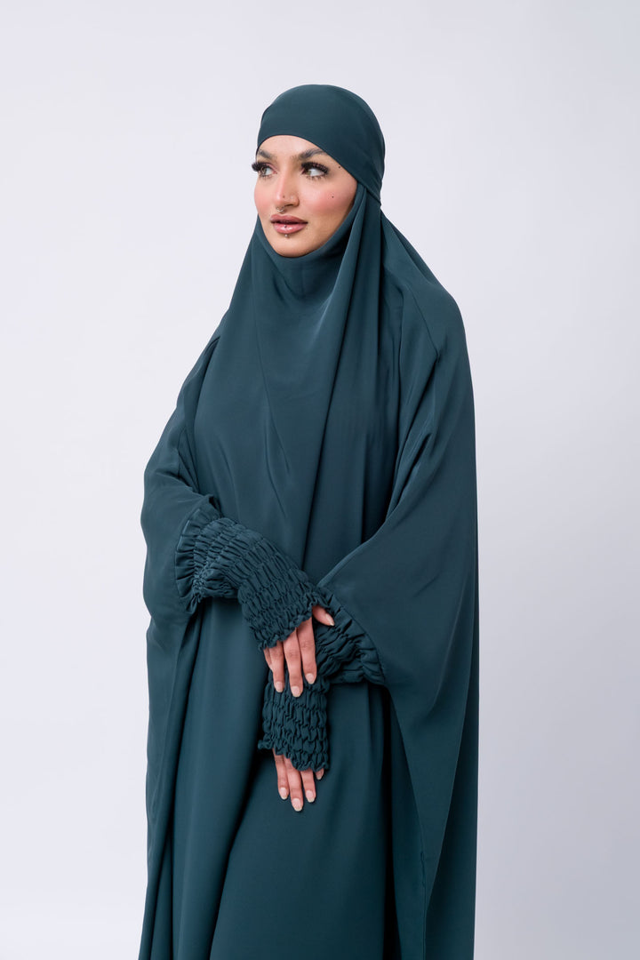 Modest wear dark teal jilbab with ruched cuffs, ideal Islamic outfit for prayer and daily coverage.