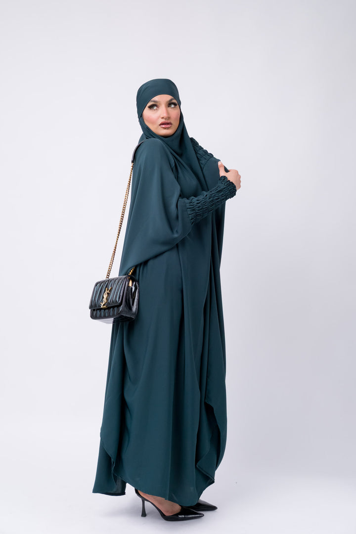 Dark teal khimar with smocked sleeves, modest Islamic outfit for Muslim women, full coverage prayer wear.