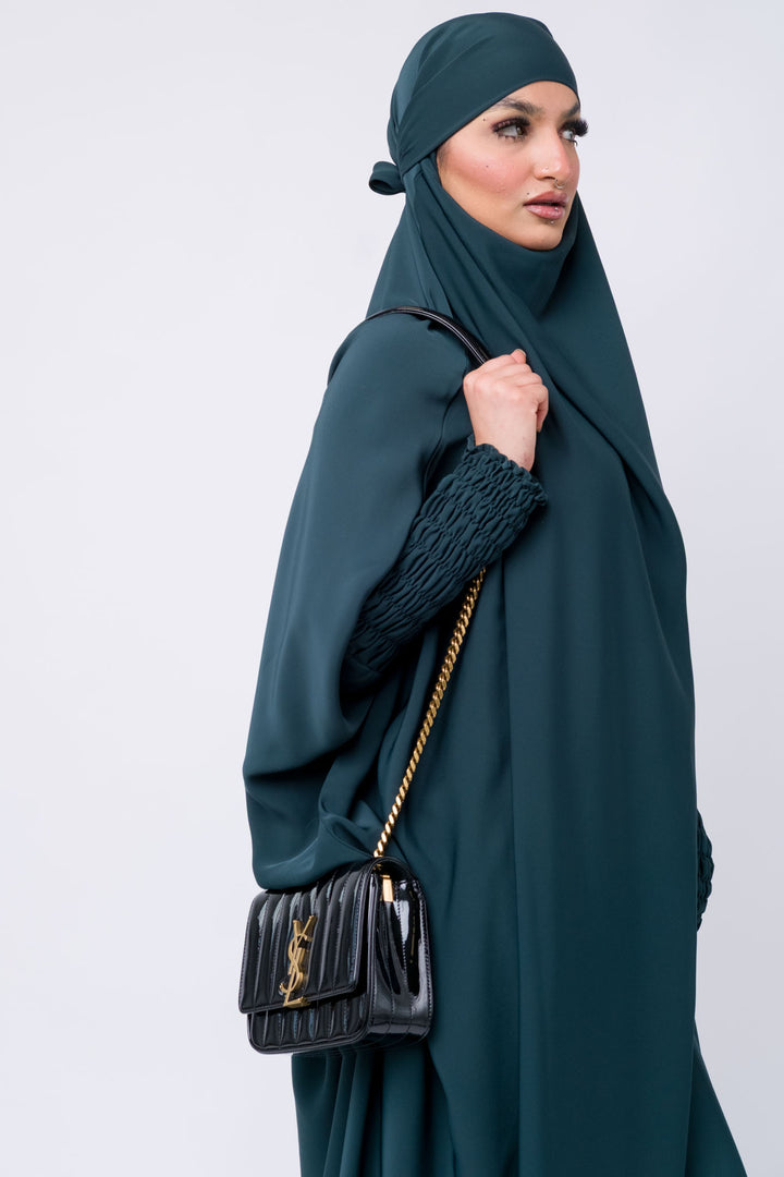 Comfortable dark teal khimar for Muslim women, smocked sleeve design for stylish and modest look.