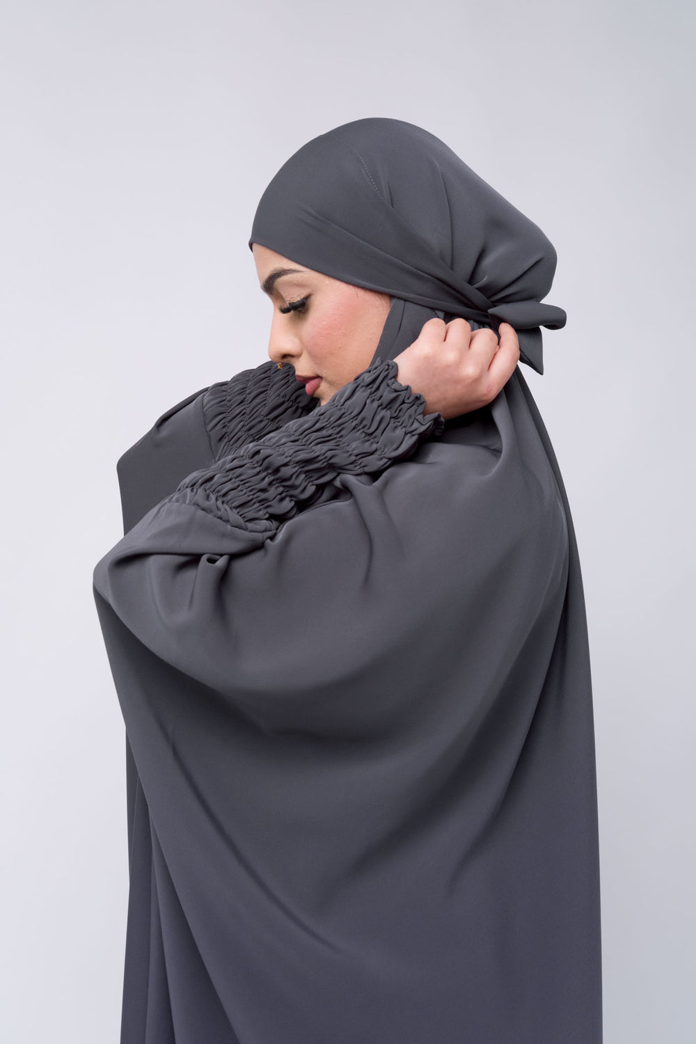 Modest grey jilbab khimar with gathered sleeves, lightweight abaya style for everyday wear.