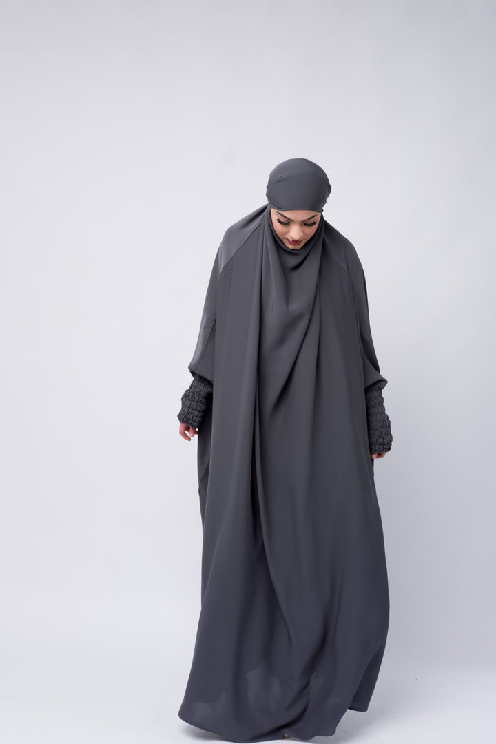 Flowy grey abaya-style khimar with elegant ruched sleeves, perfect for prayer and outings.