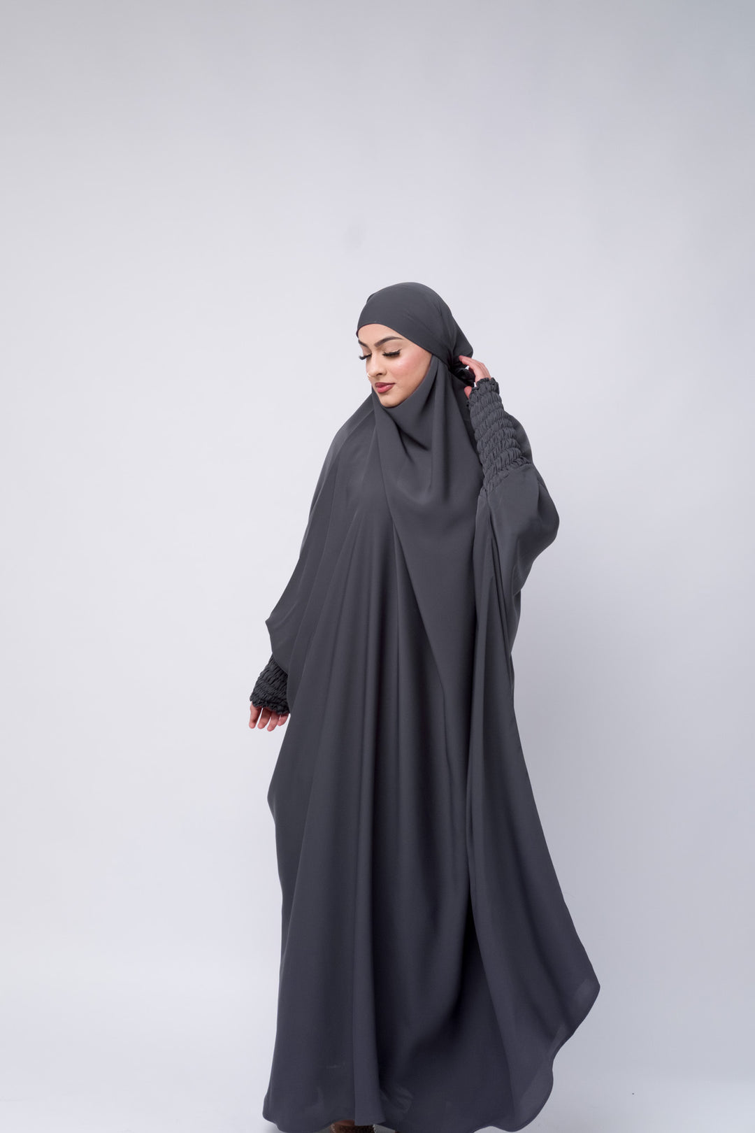 Chic full-length grey khimar for women, Islamic modest wear with smocked sleeve detailing.