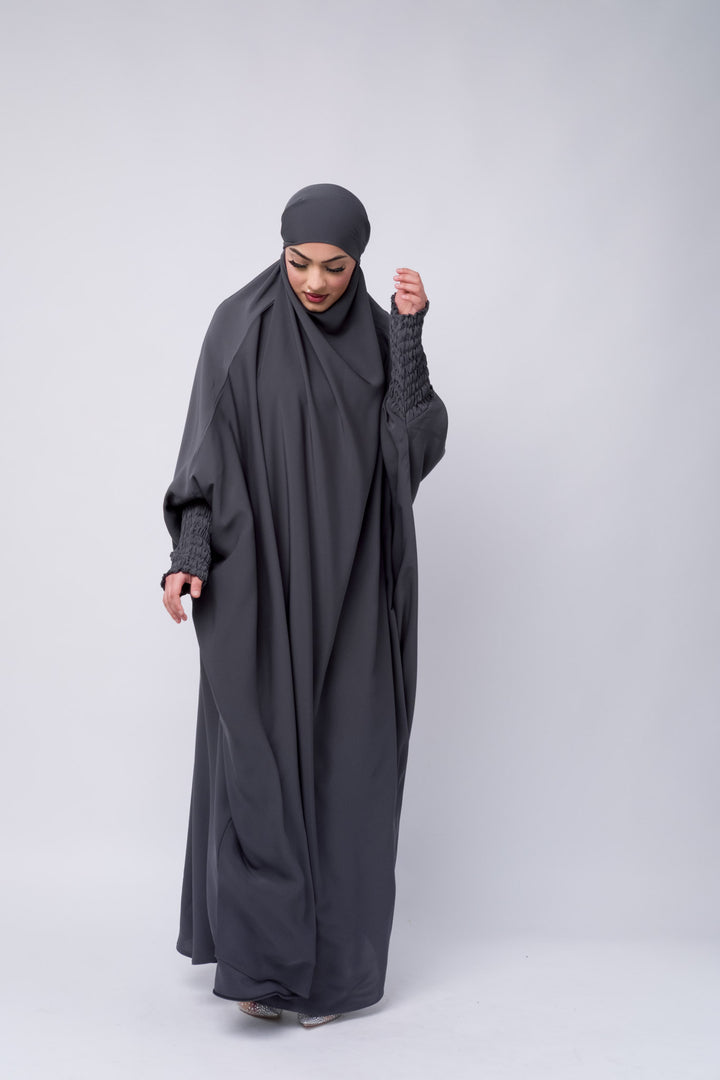 Grey modest khimar with long coverage and smocked sleeves, perfect Islamic clothing for women.