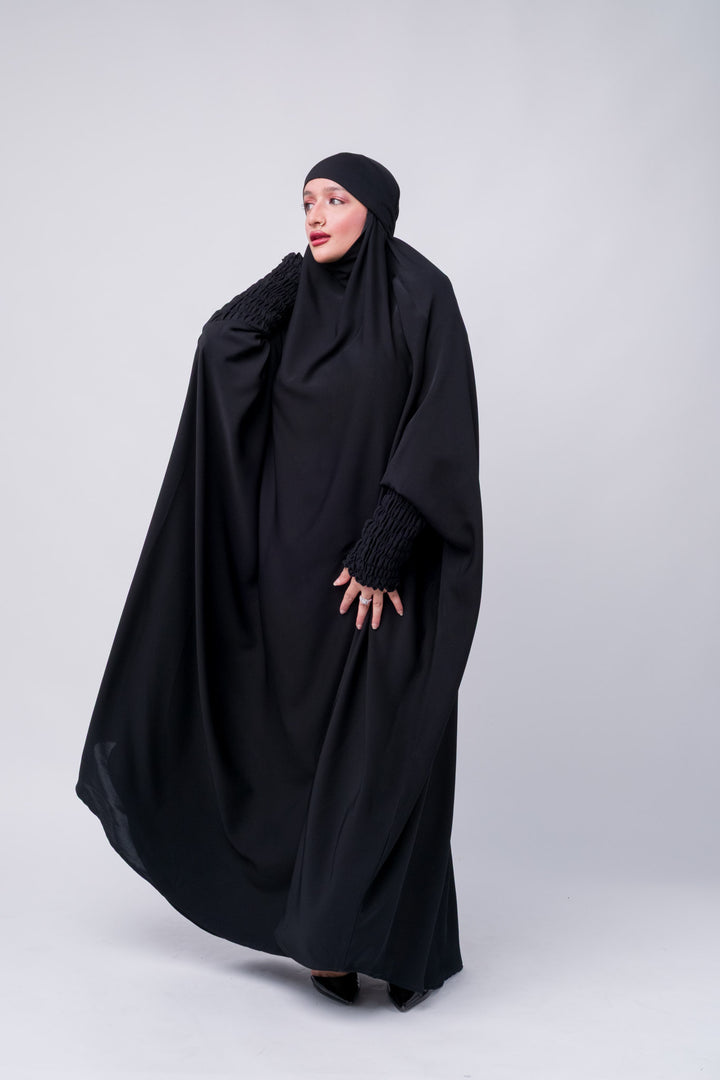 Elegant black prayer abaya with cuffed ruched sleeves, ideal for conservative modest fashion style.