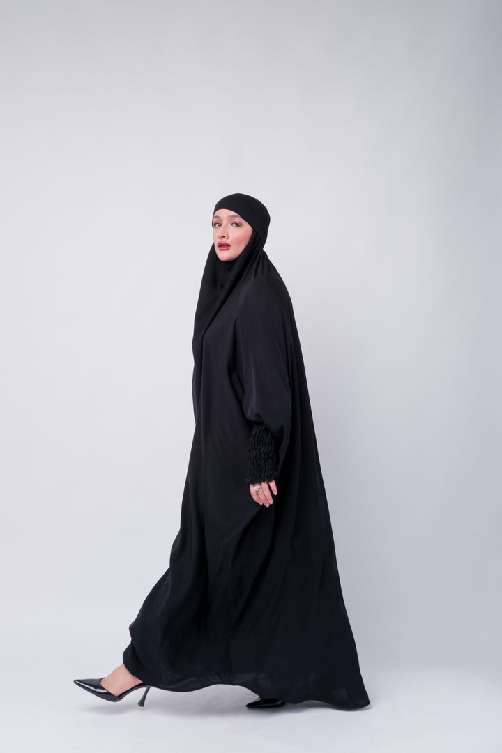 Muslim women's full-length khimar abaya in black, featuring premium fabric and gathered sleeve design