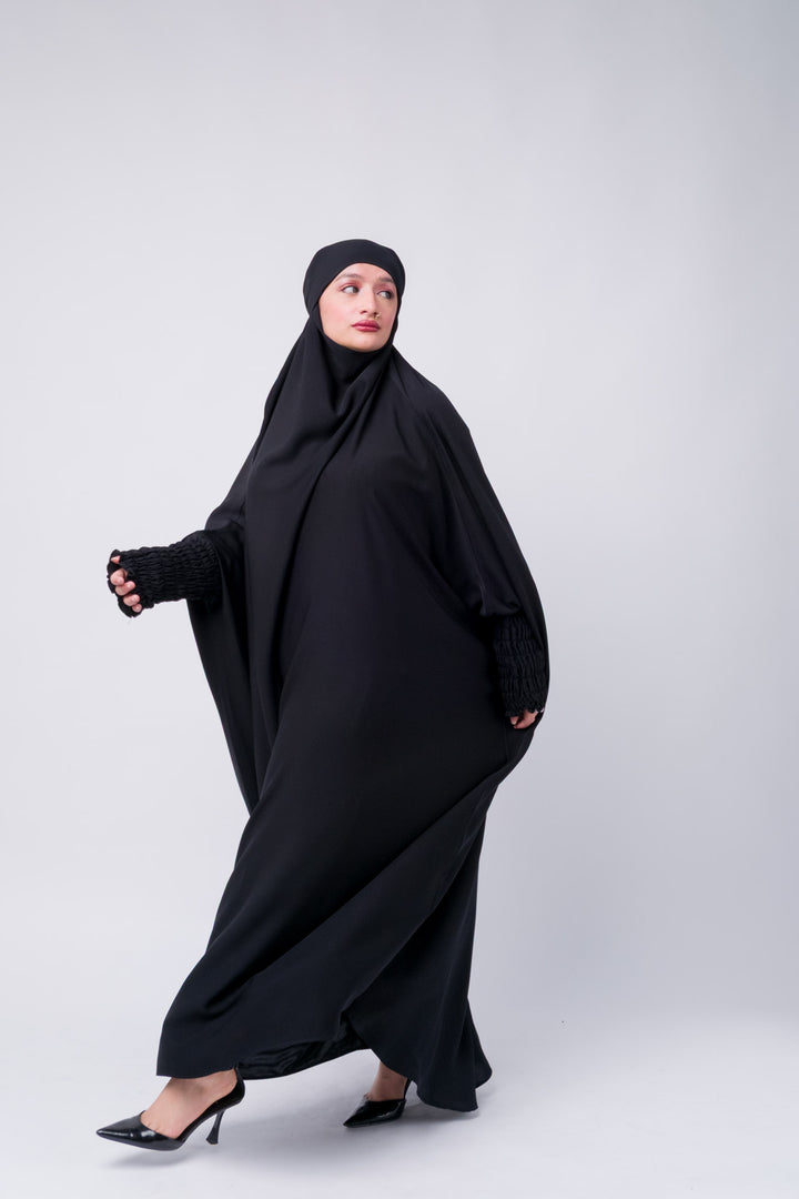  Flowing black abaya khimar set with ruched cuffs, suitable for mosque, everyday or event wear. 