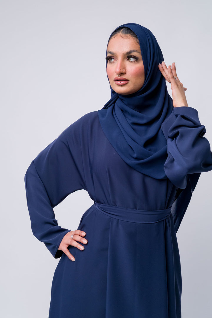 Modern navy blue abaya for women, full coverage Islamic outfit with elegant and modest design.