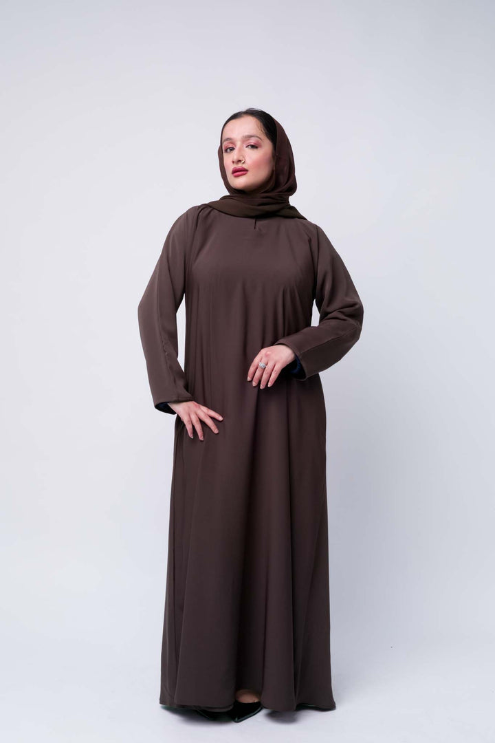 Modest brown abaya for women with hijab, breathable fabric and full-length design. 