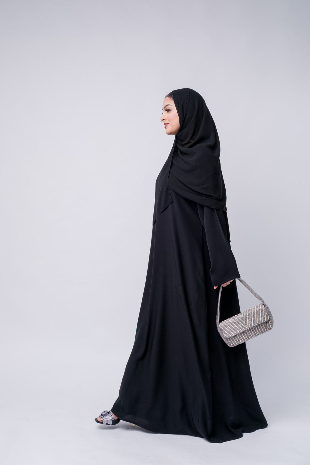 Stylish black abaya dress with waist tie and flowy fit, ideal for modern modest fashion lovers.