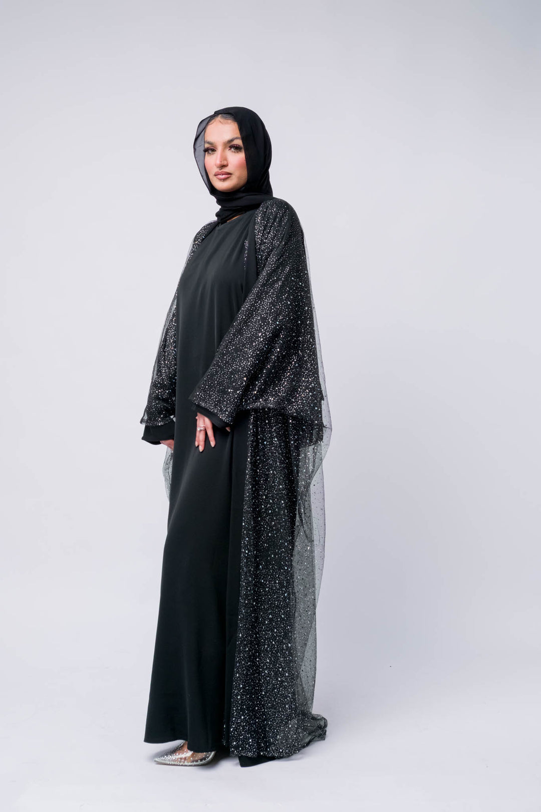 Luxury black 3-piece abaya set with embellished Toor net overlay, paired with a Nidha inner slip. Made in UAE.