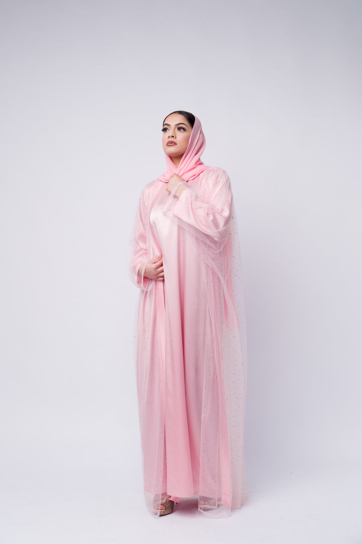 Modest pink satin abaya with sparkly chiffon overlay and scarf, perfect for Islamic events 