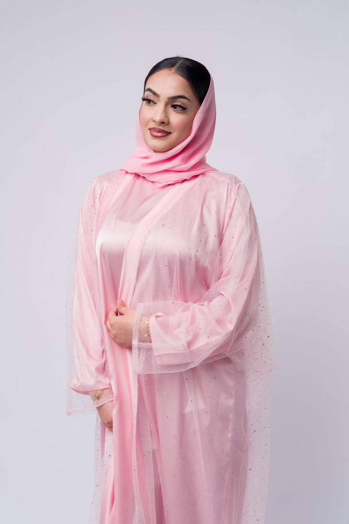 Elegant modest abaya in soft pink satin with glitter detail and scarf, great for festive wear 