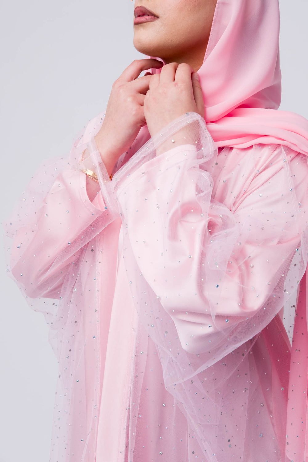 Soft pink abaya dress with sheer embellished outer layer, ideal for Eid and special occasions