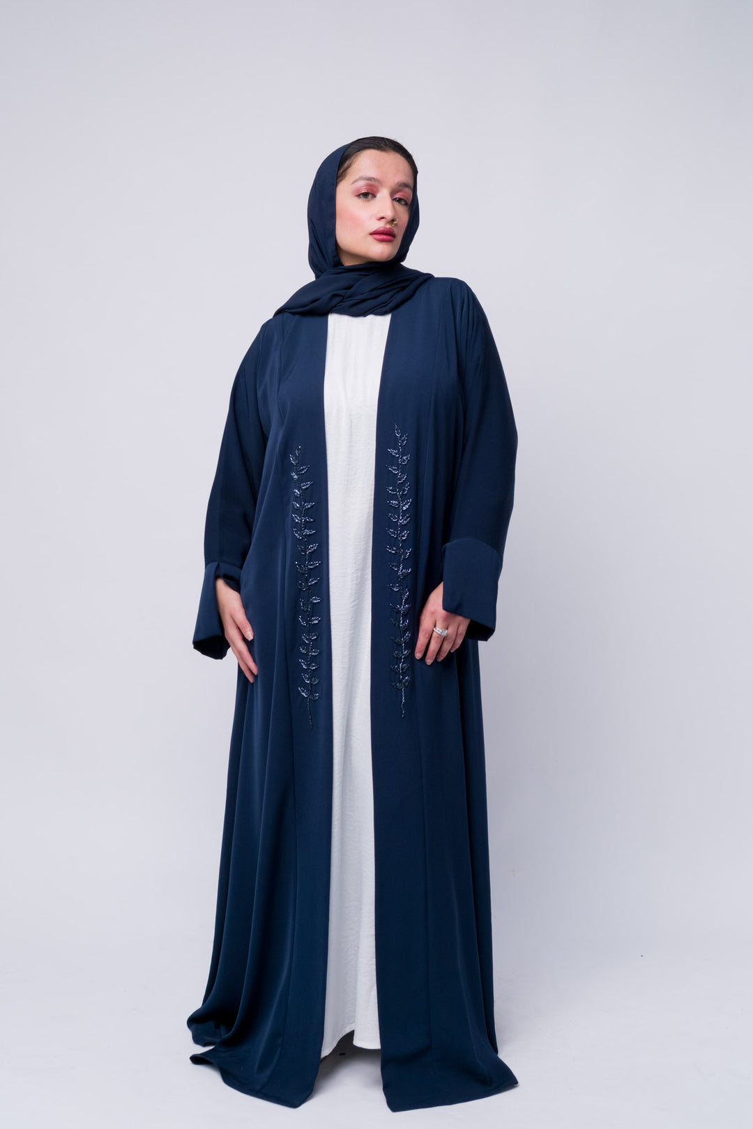 Elegant navy blue embroidered abaya with modest fit and front detailing for women.