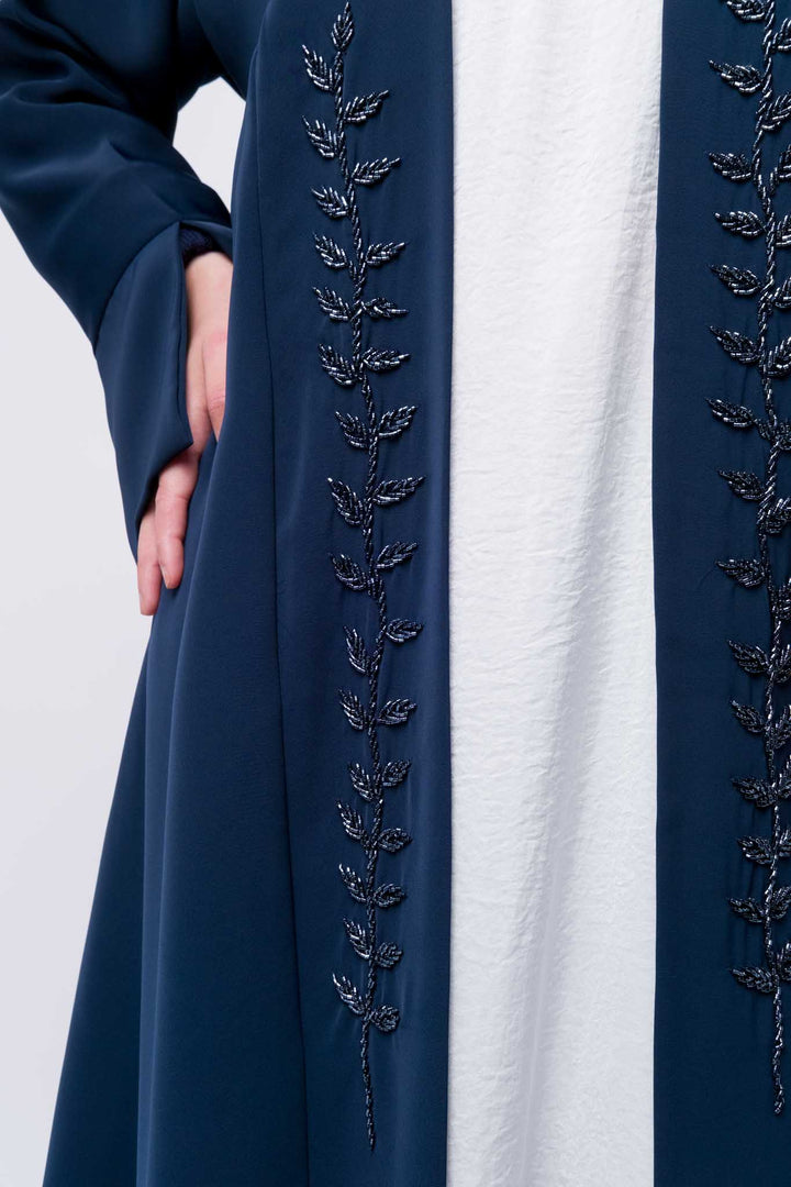 Premium modest navy blue abaya with intricate hand-stitched embellishment design.