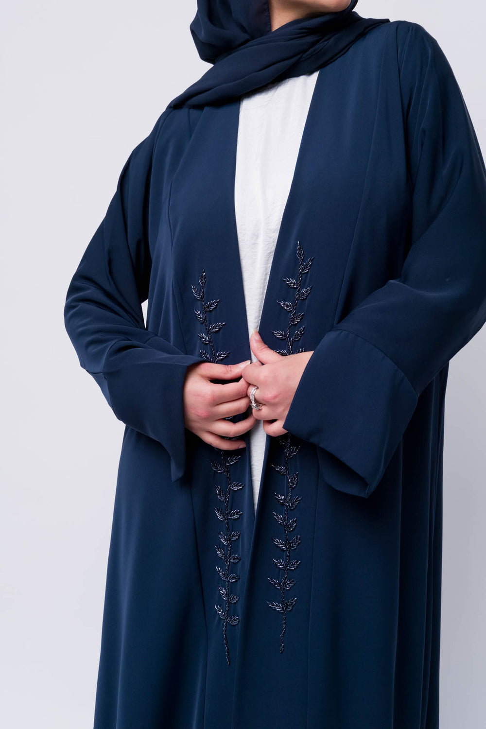 Navy blue open abaya with leaf embroidery, perfect for modest fashion lovers.