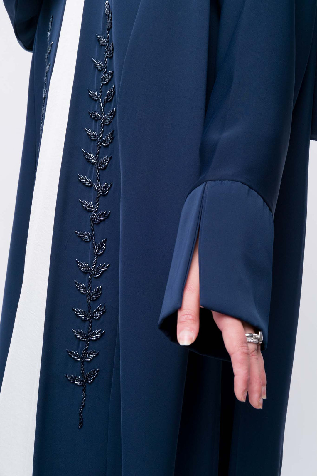  Modest navy abaya with long sleeves and delicate leaf embroidery, elegant everyday wear.