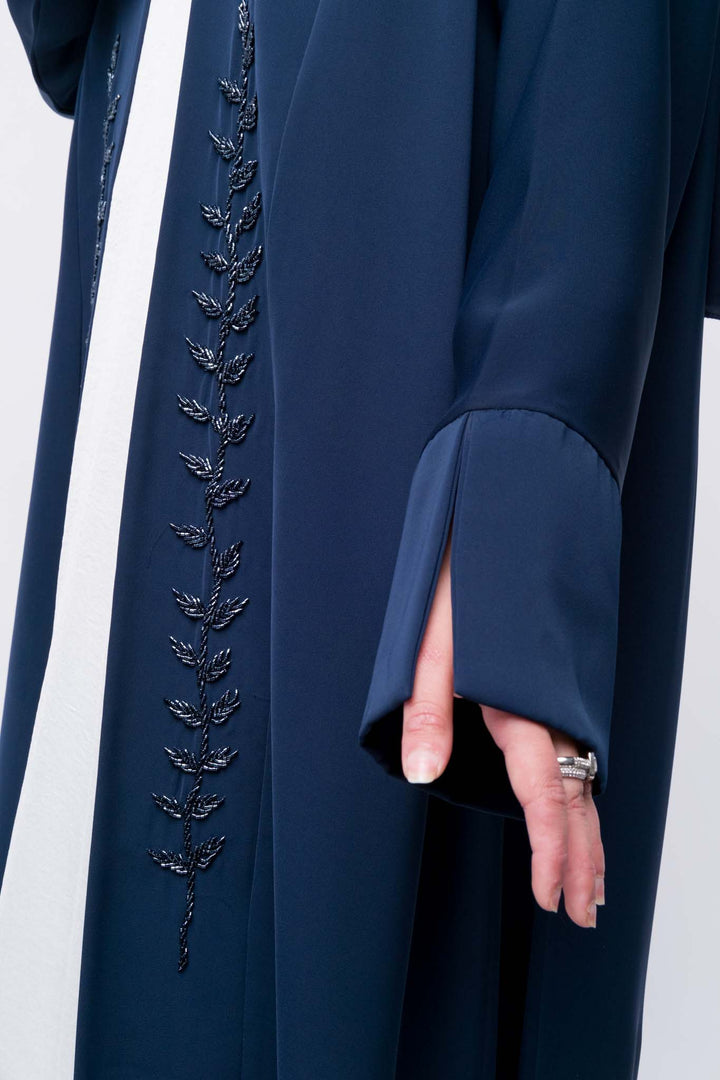  Modest navy abaya with long sleeves and delicate leaf embroidery, elegant everyday wear.