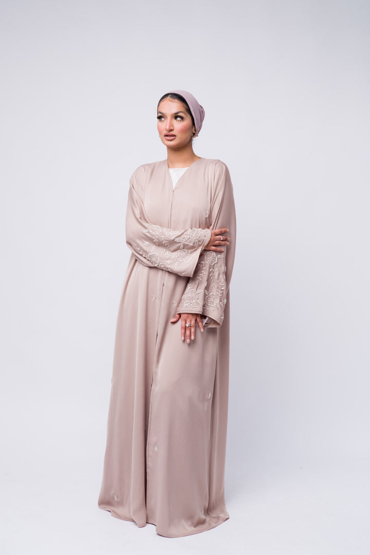 Lightweight nude abaya with hand-beaded sleeve design, elegant Eid outfit idea. 