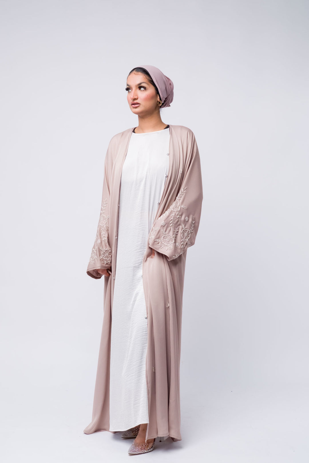Elegant nude pink embroidered abaya with floral beaded sleeves, perfect for Eid, Ramadan, and formal occasions.