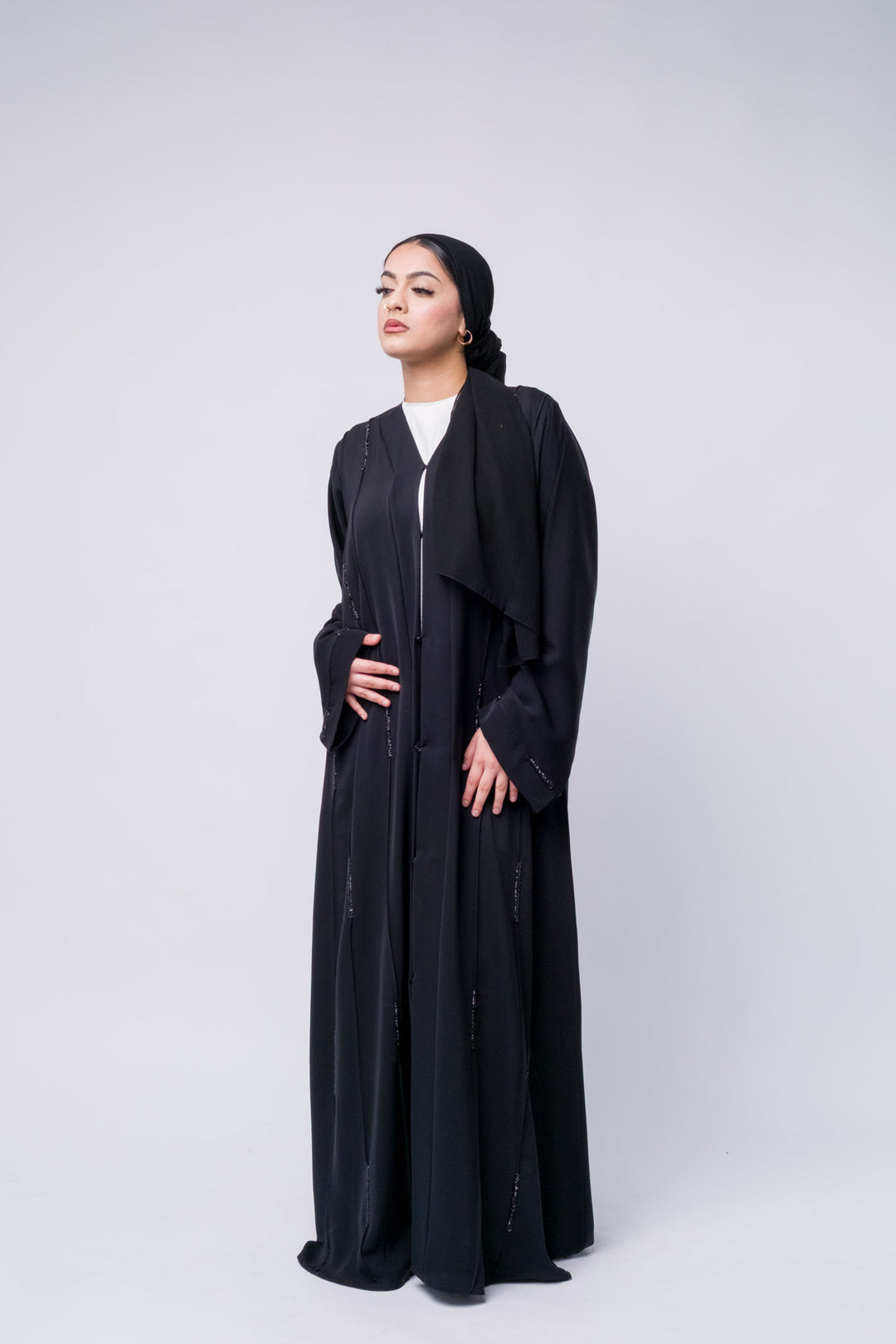 Black open front abaya with sequin details, perfect for modest fashion and elegant evening looks.