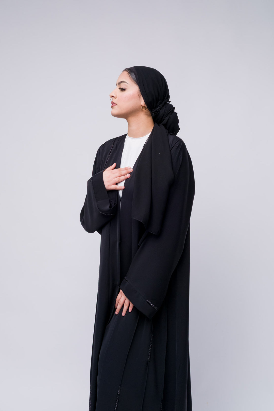 Stylish open abaya in black with delicate bead detailing, great for modern modest fashion.