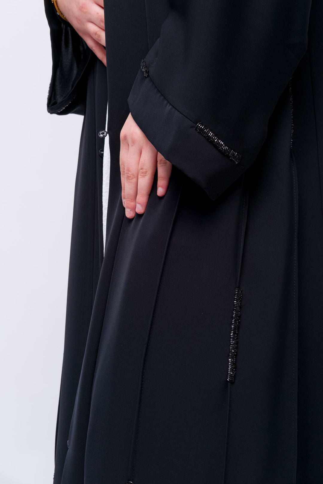 Classic black abaya with hand beaded details, front-open silhouette for effortless layering.