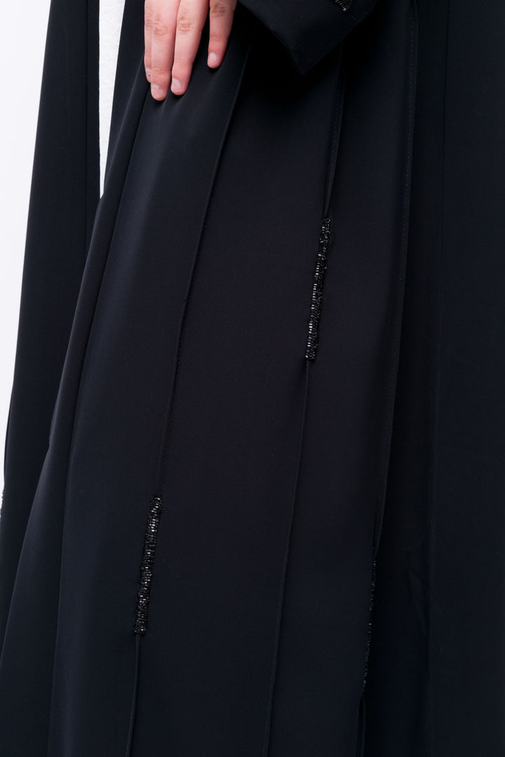 Lightweight black open abaya with sequin streaks, modern take on traditional modest fashion.