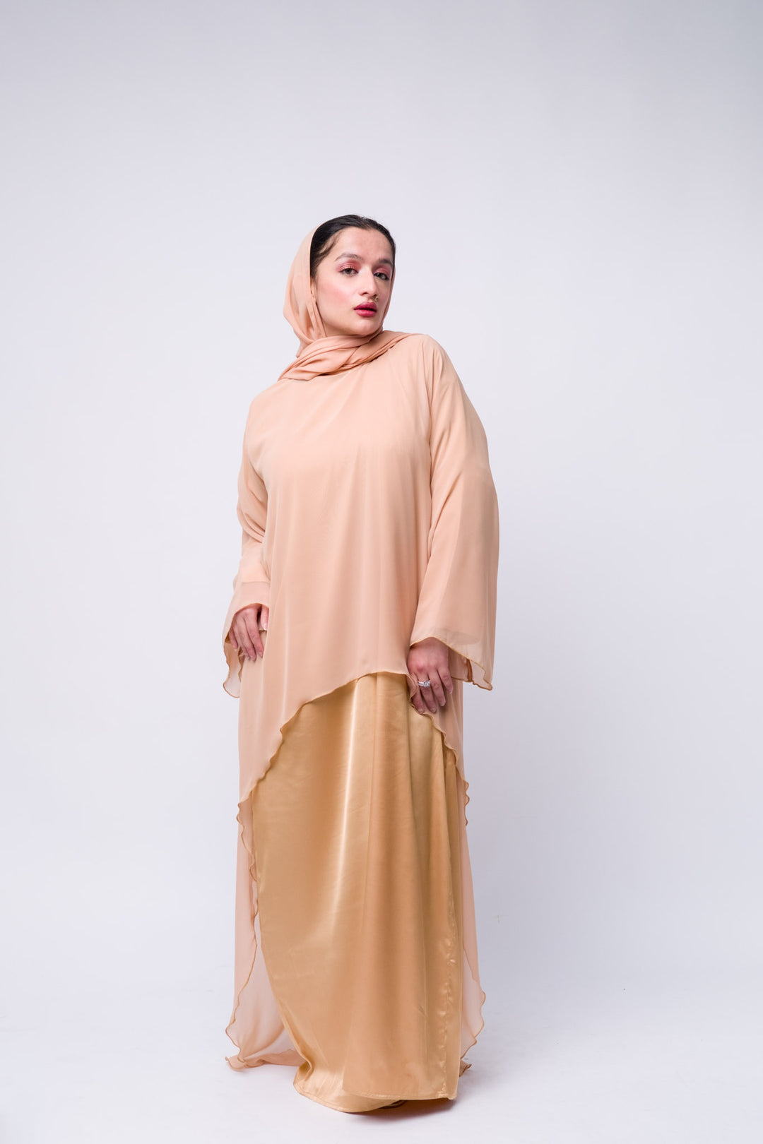 Peach layered abaya with satin inner lining and chiffon overlay, modest fashion for women.
