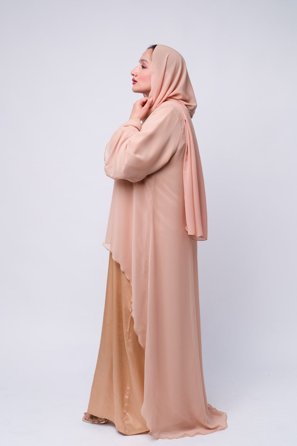 Elegant peach satin abaya dress with chiffon top layer, perfect for Eid or formal occasions.