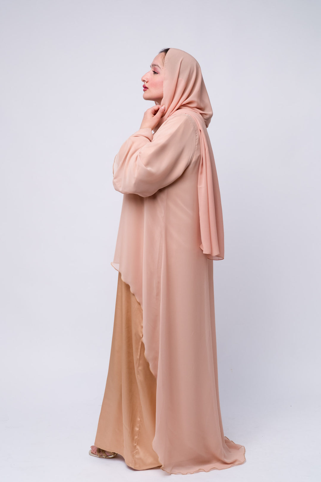 Elegant peach satin abaya dress with chiffon top layer, perfect for Eid or formal occasions.