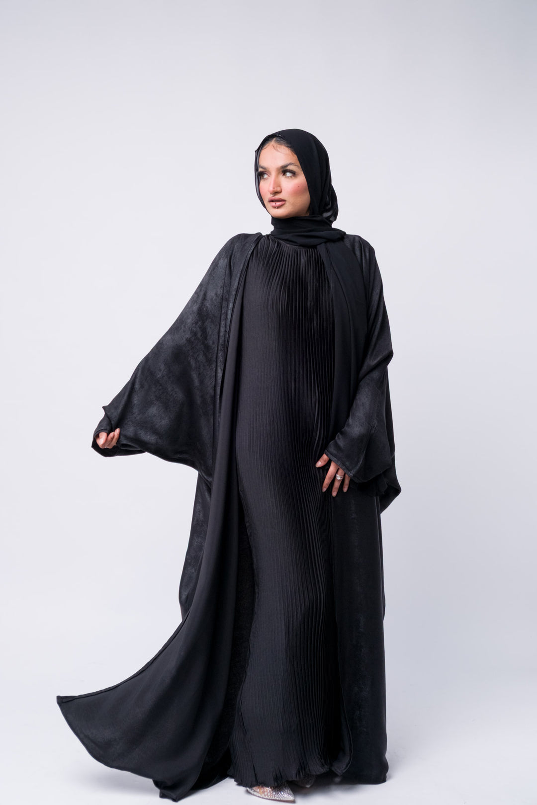 Stylish black abaya with textured satin fabric, ideal for Eid, formal wear, or modest evening outfit.
