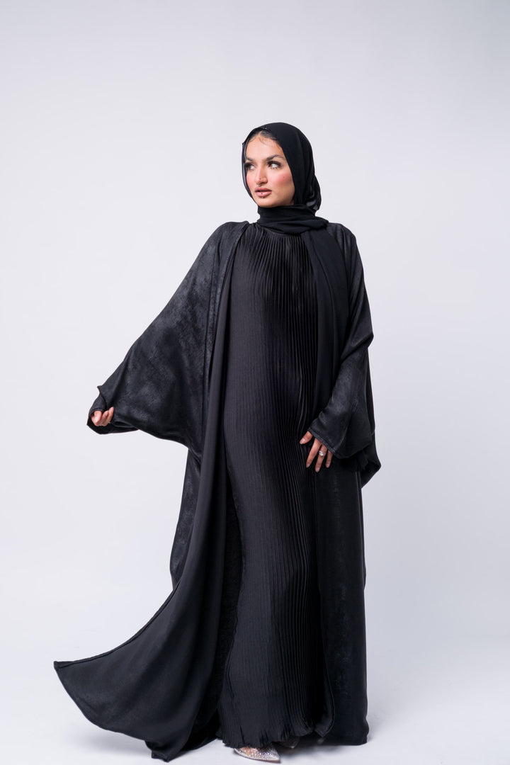 Stylish black abaya with textured satin fabric, ideal for Eid, formal wear, or modest evening outfit.