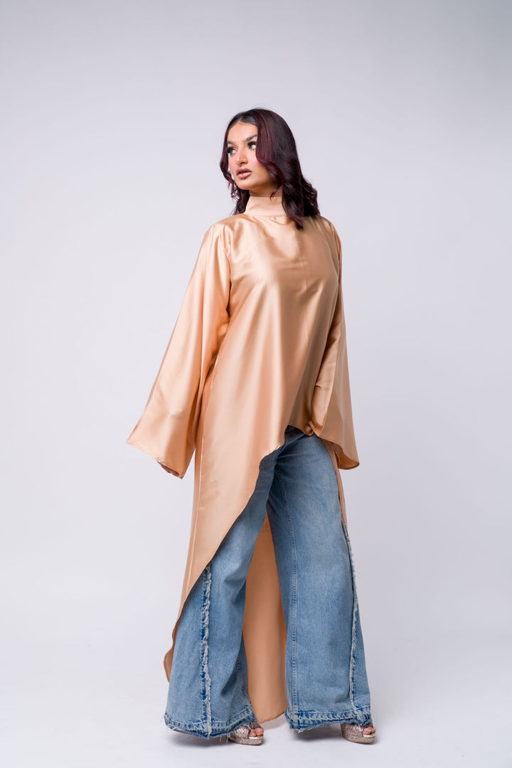 Long peach satin tunic with distressed jeans – modest street style for women