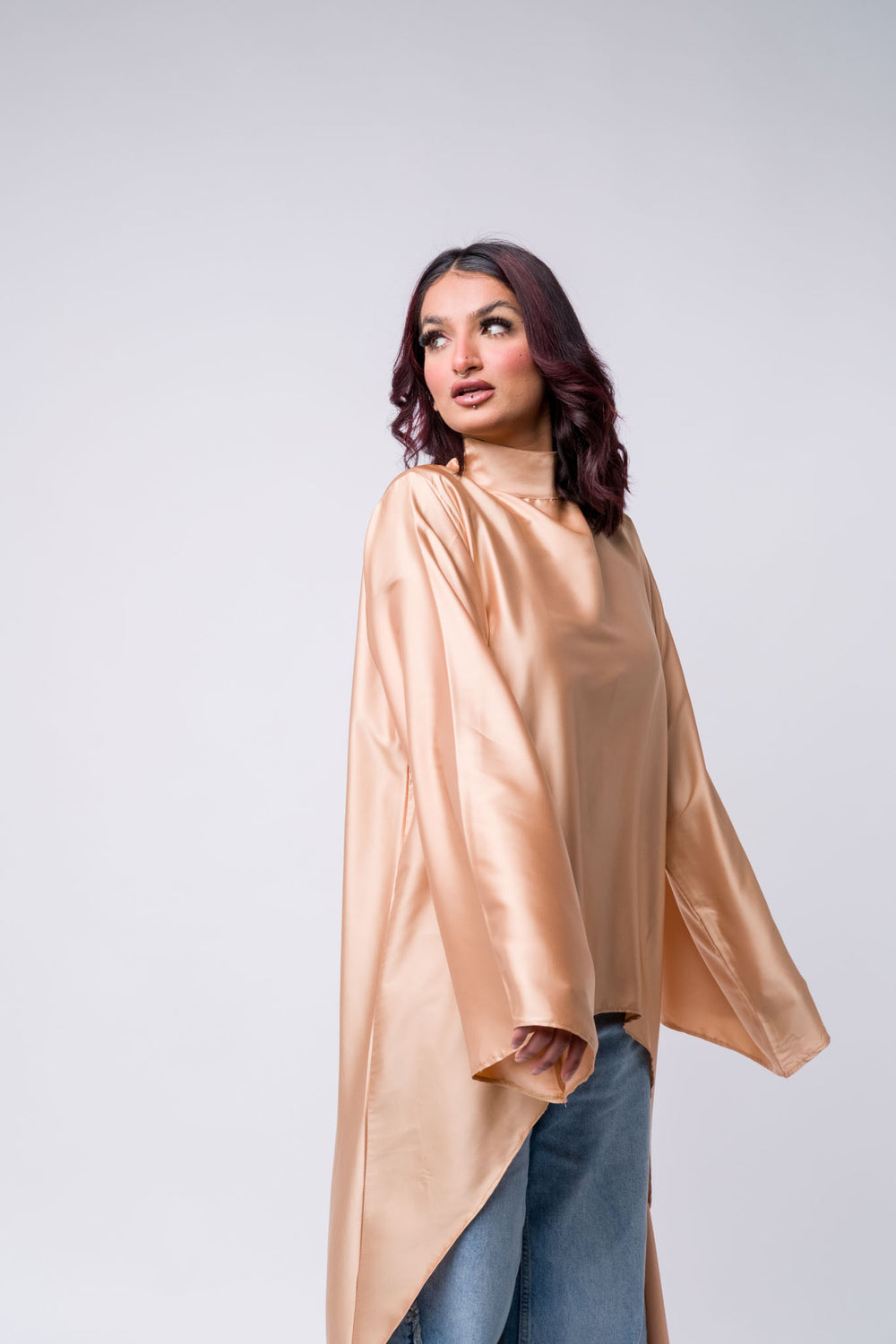 Flowing silk peach blouse with flared ripped jeans – trendy modest outfit for women 