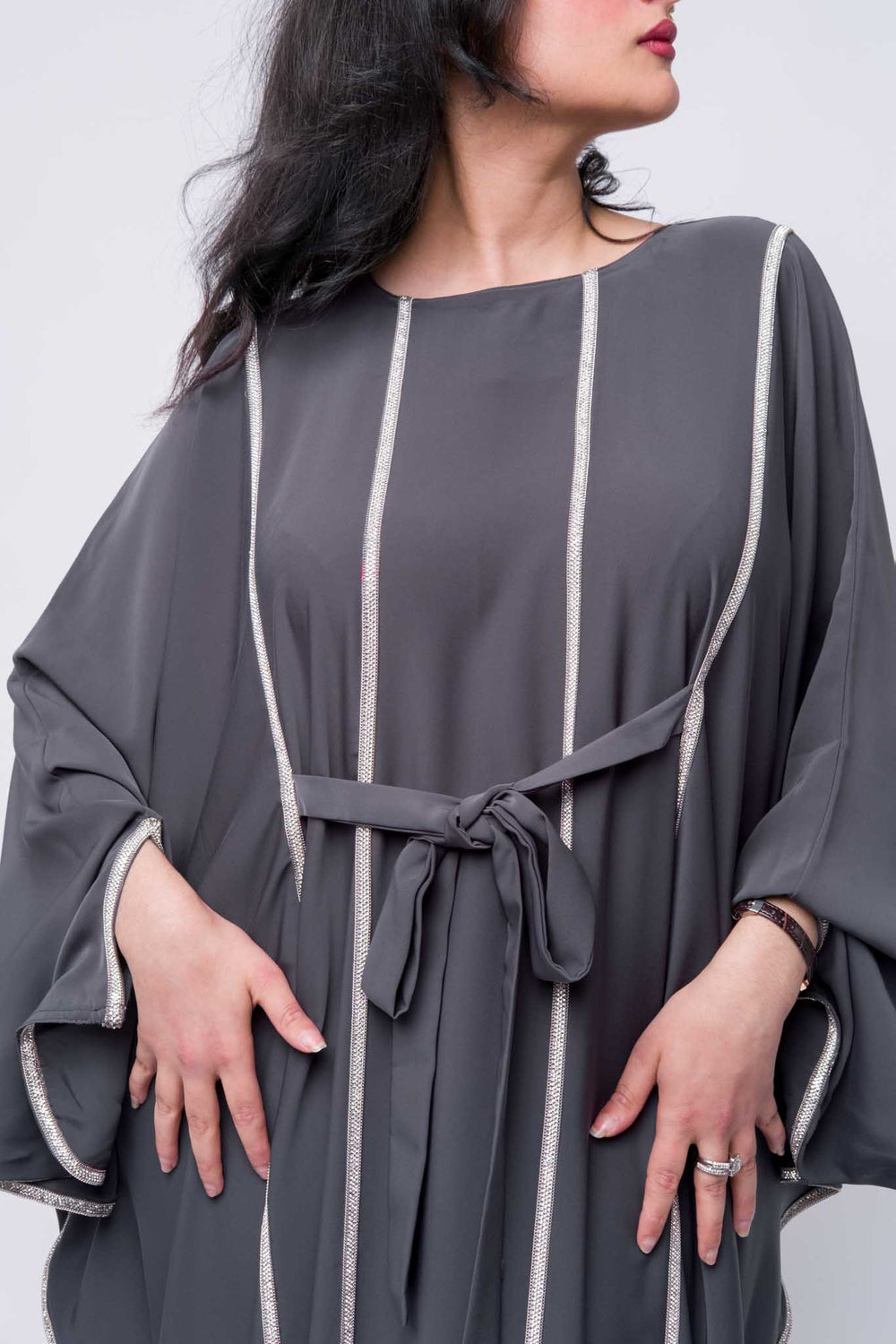 Grey flowy abaya with sparkle detailing and waist belt, ideal for evening wear and parties.