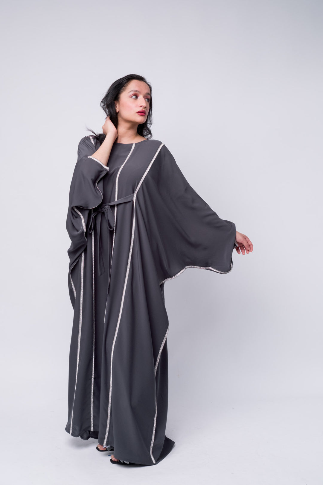 Charcoal grey kaftan abaya with elegant silver trim – trendy modest fashion outfit. 