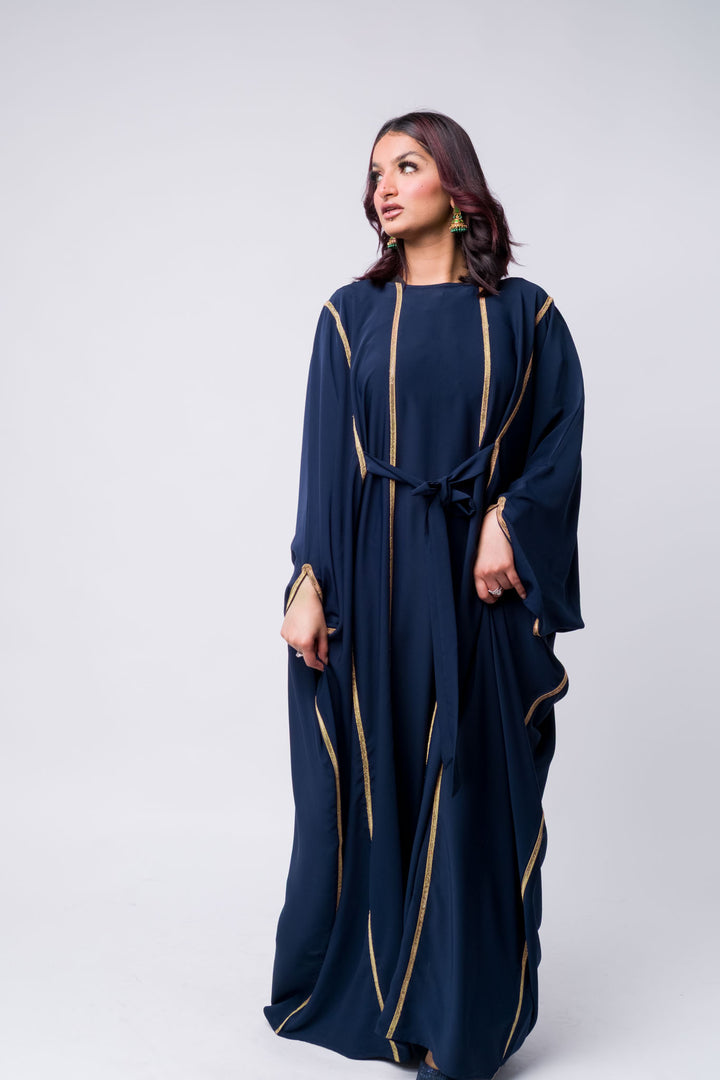 Elegant navy blue kaftan for women, featuring gold stripes and loose fit for modest fashion.