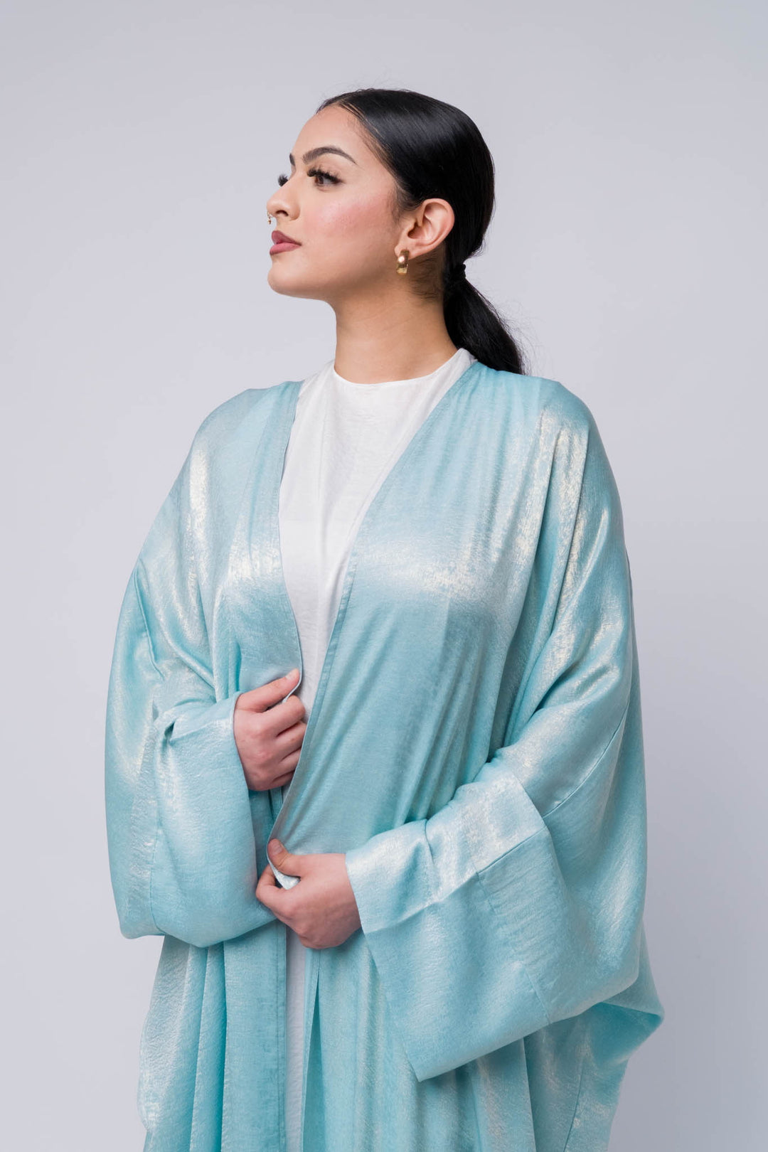Soft shimmering abaya in metallic light blue, perfect for modest fashion styling