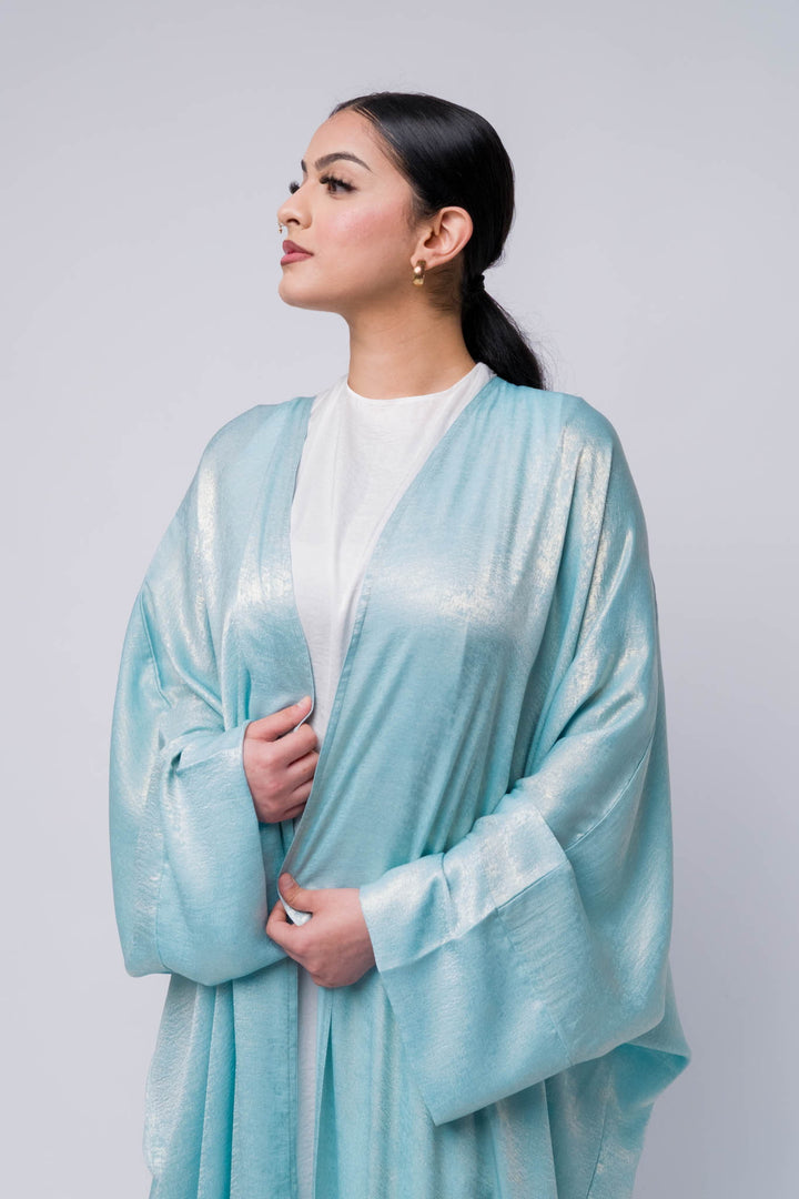 Soft shimmering abaya in metallic light blue, perfect for modest fashion styling