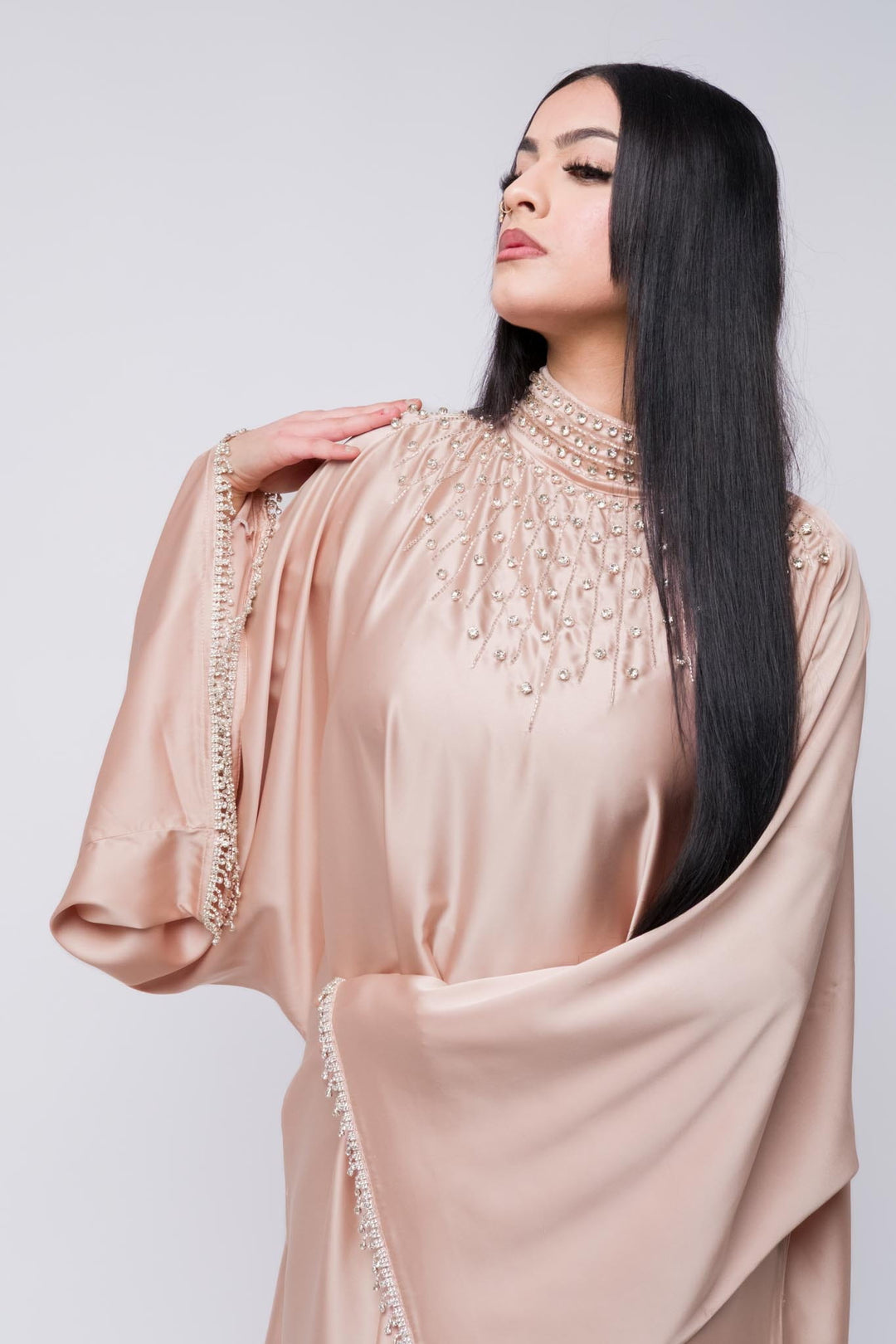 Pink abaya with intricate beaded high neckline and fringe beaded sleeves.
