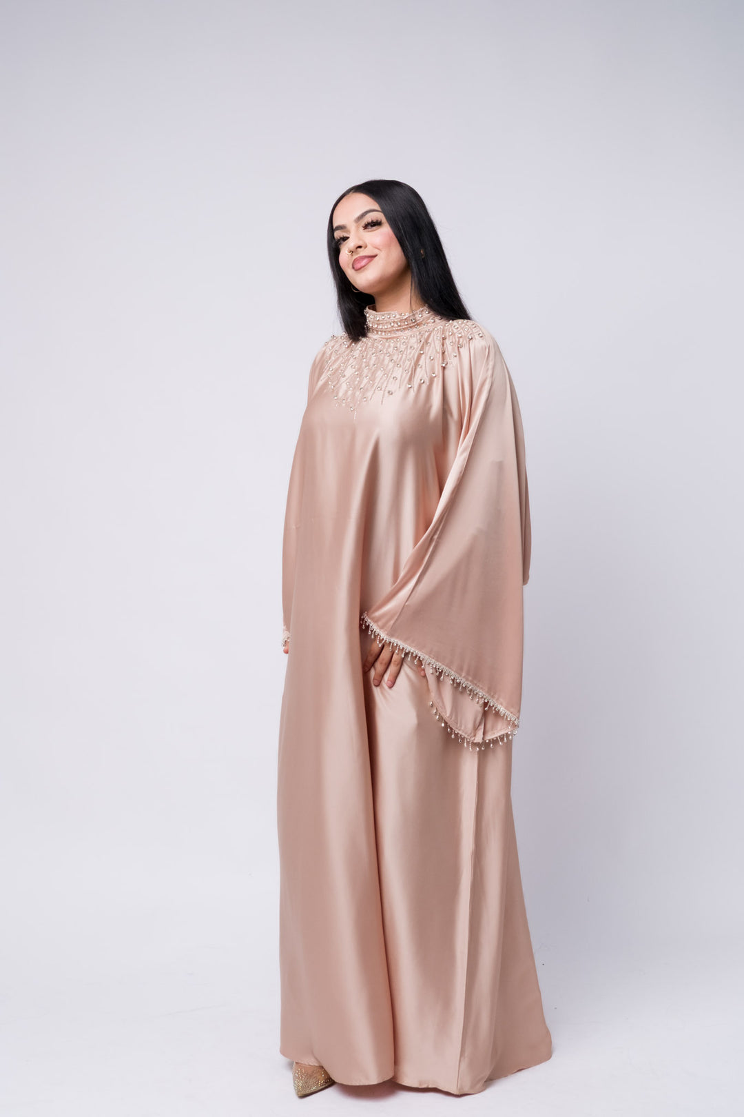 Elegant modest beige abaya with pearl accents – perfect for Eid or formal gatherings 