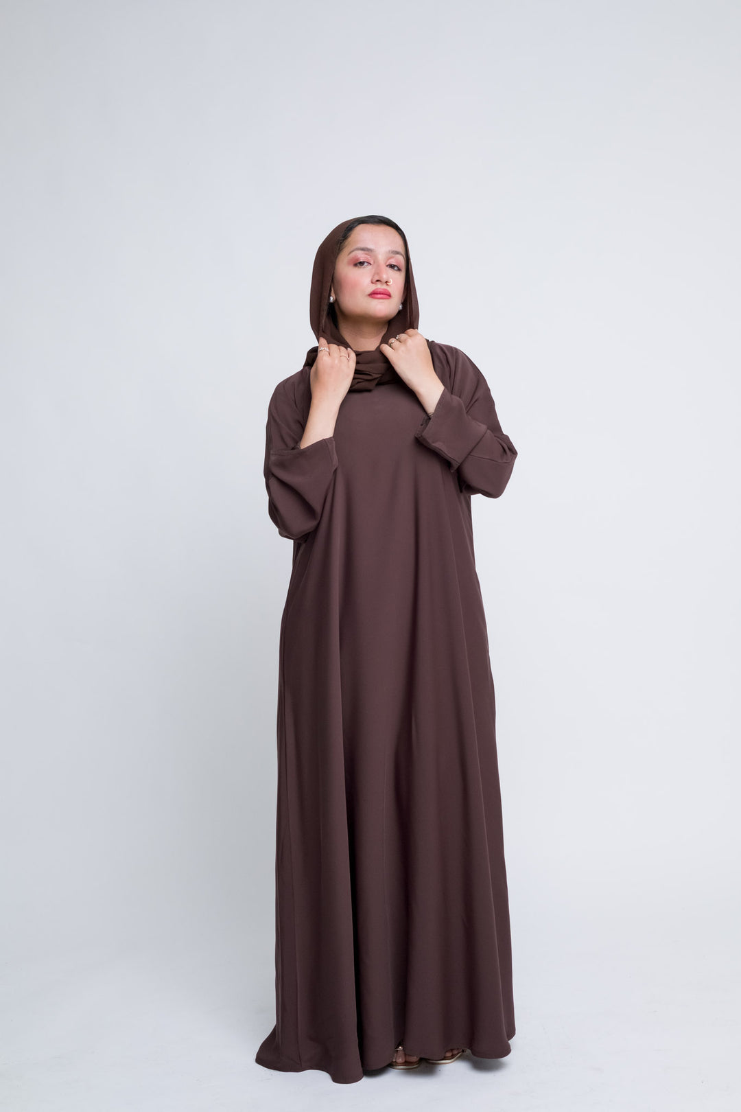 Flowy chocolate brown abaya with matching hijab, modest fashion for Muslim women. 
