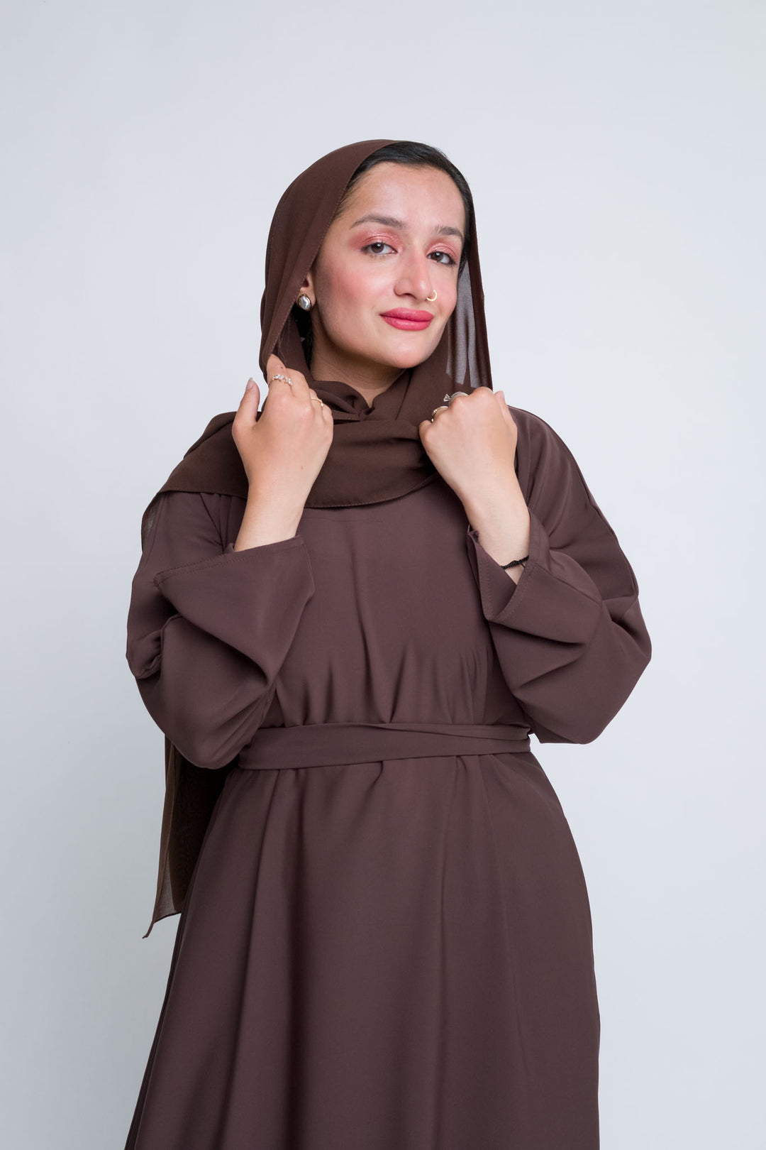 Dark brown abaya with full sleeves and hijab, flowy fabric perfect for every season. 
