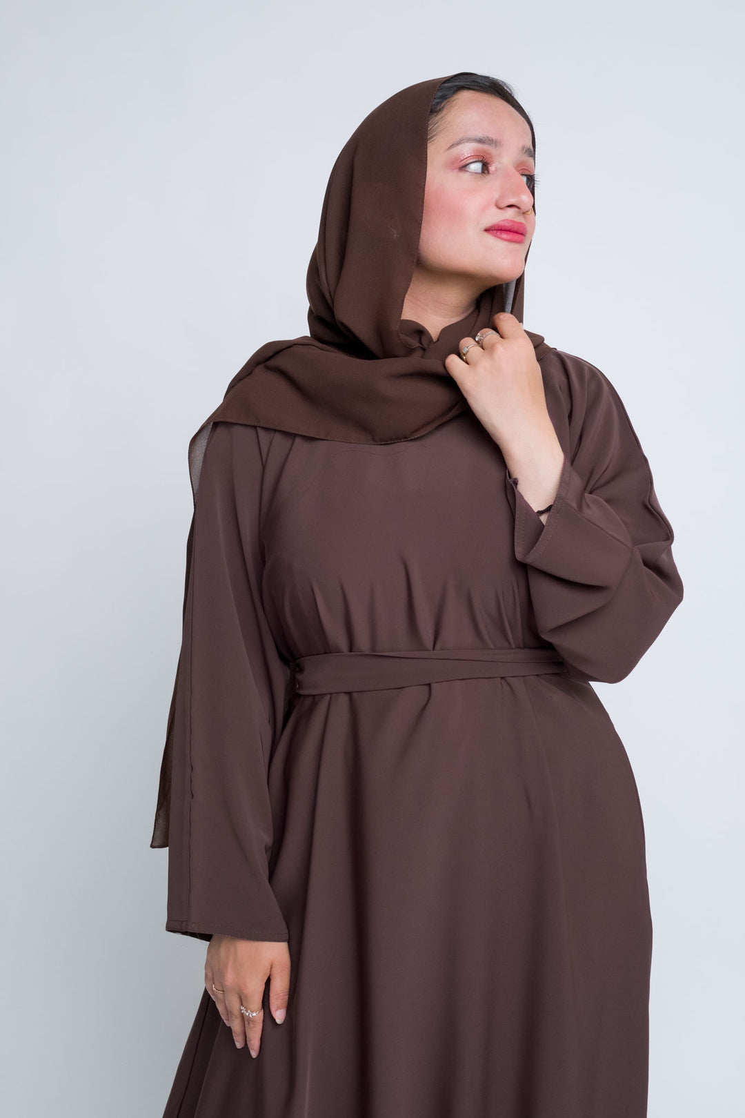 Modest brown abaya for women with hijab, breathable fabric and full-length design.  