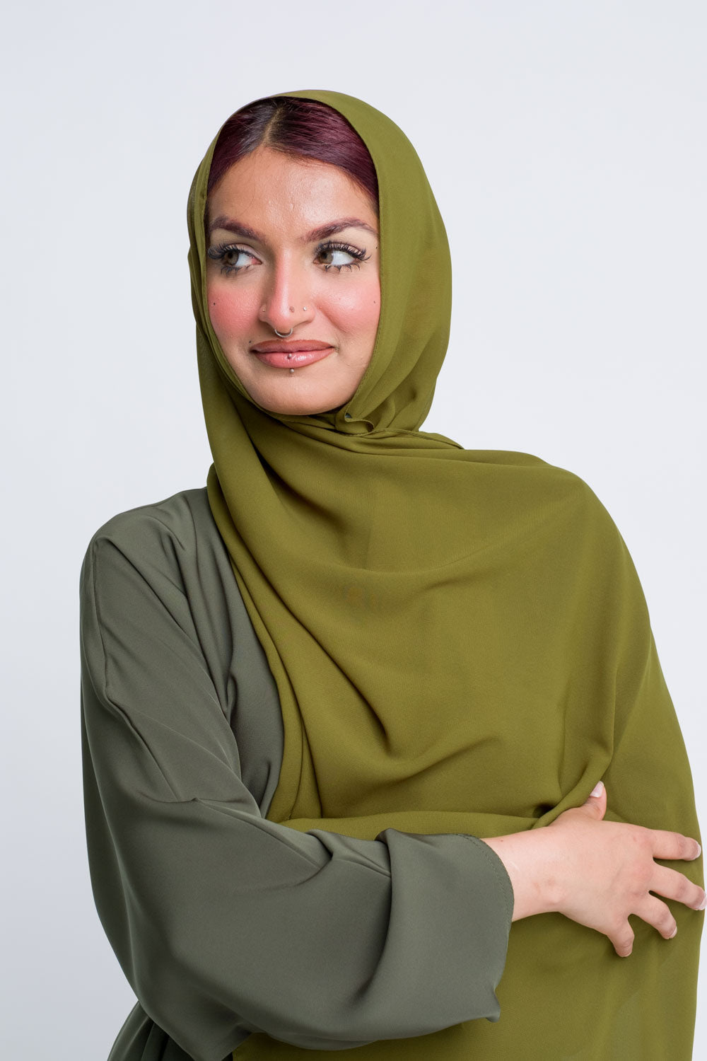 Lightweight olive green chiffon hijab styled for casual elegance.