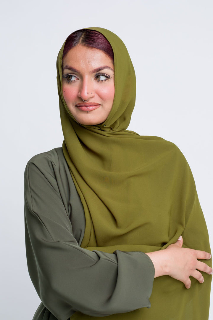 Lightweight olive green chiffon hijab styled for casual elegance.